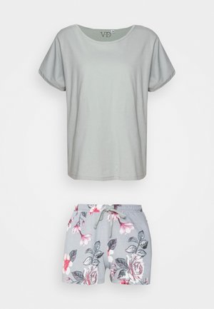 Light gray short-sleeve top paired with floral-patterned gray shorts featuring a drawstring waist. Soft fabric with a relaxed fit.