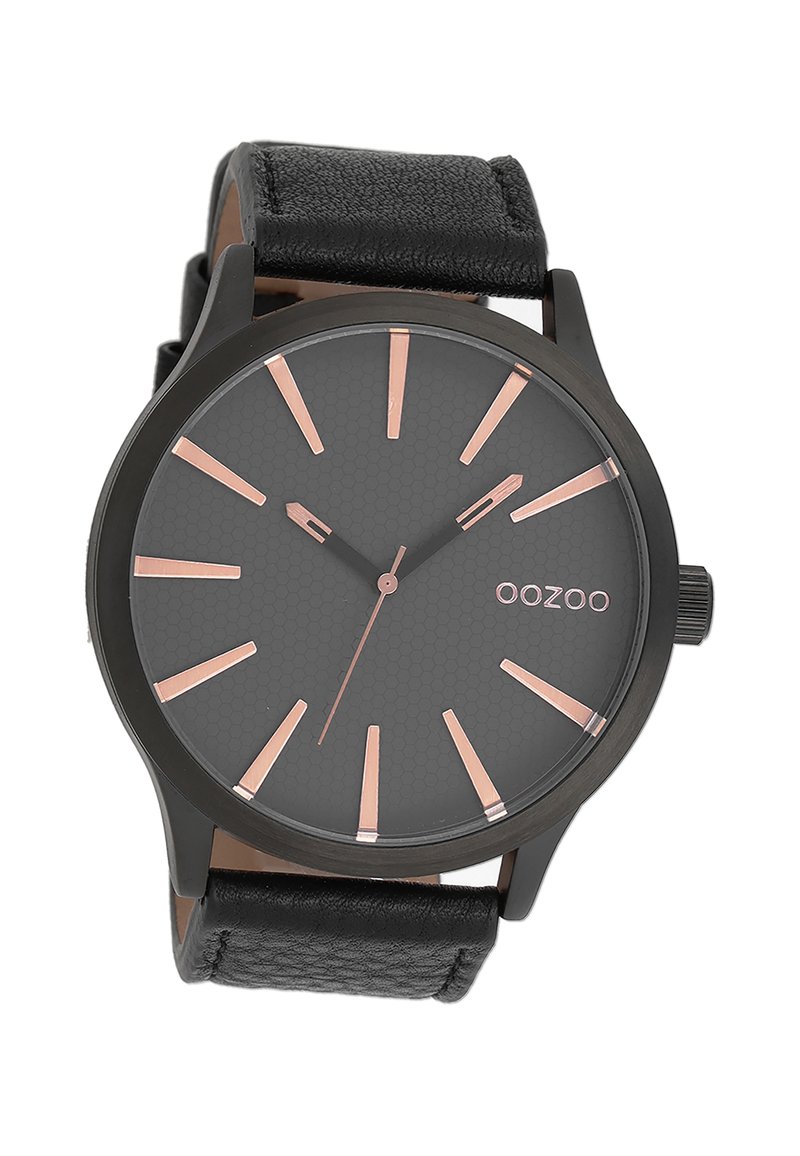 Montre analogique noire avec un cadran gris texturé, des index d'heure en or rose, et un bracelet en cuir noir. Présente un boîtier rond et un design minimaliste.