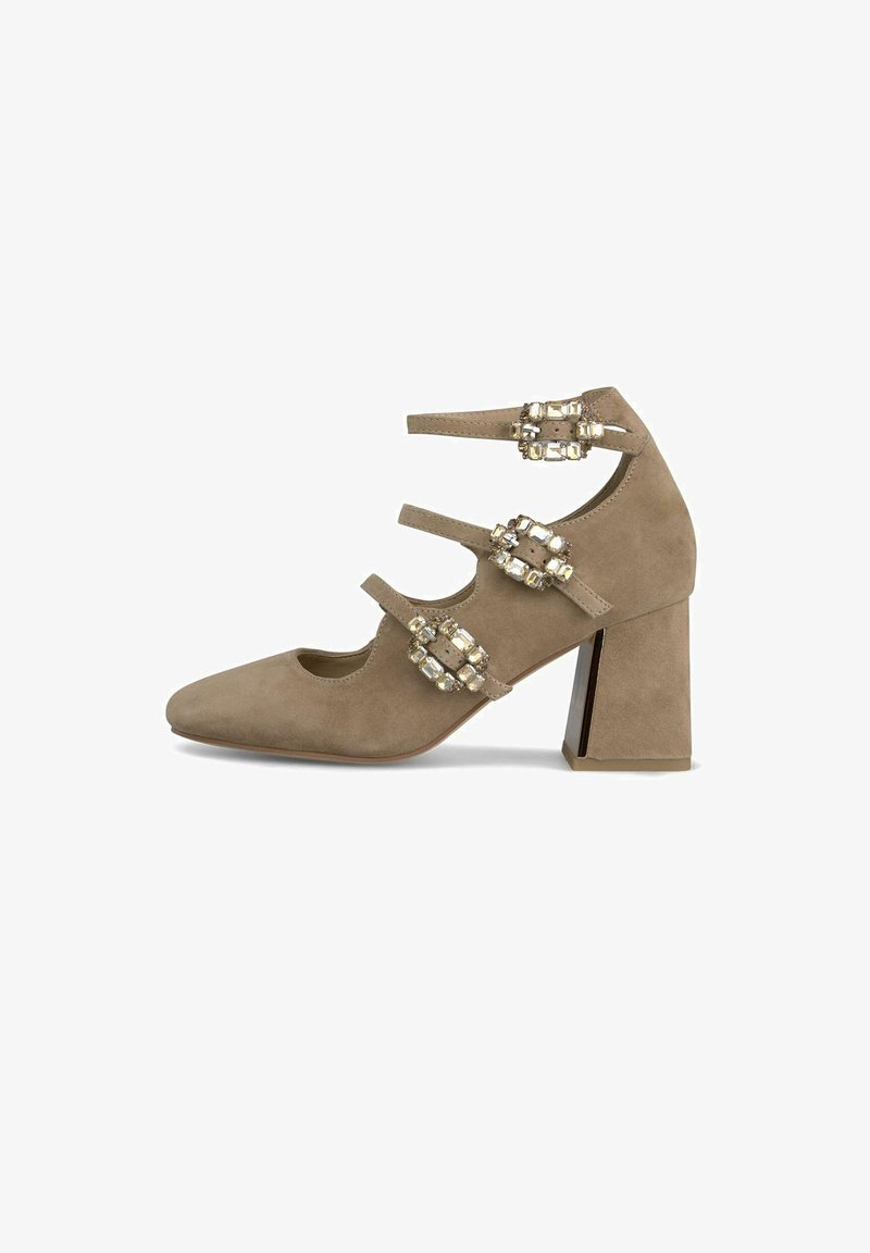 Beige Wildlederschuh mit spitzem Zehenbereich, drei dekorativen Riemen mit Kristallakzenten und einem breiten Blockabsatz mit metallischen Details.