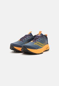 Running shoes in dark blue with orange accents. Durable fabric upper, textured finish, reinforced toe, and black textured outsole.