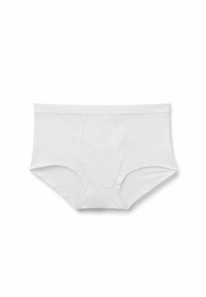 Mutande da uomo bianche stile slip con elastico in vita e cuciture frontali sagomate, distese su sfondo bianco.