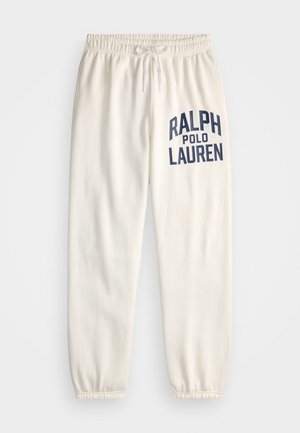 Cream-colored sweatpants made of soft cotton, featuring a large navy print of "RALPH POLO LAUREN" on the left leg and elastic cuffs.