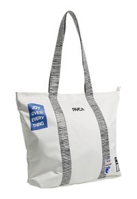 White canvas tote bag with black and white striped shoulder straps, featuring a blue graphic that states "JOY OVER EVERY THING" and logo.