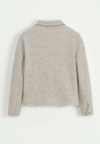 Veste en laine gris clair avec col, manches longues et poignets boutonnés. Tissu texturé avec un motif subtil.