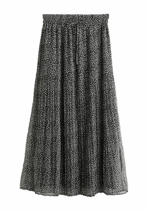Jupe midi plissée noire avec des pois blancs, taille élastique et texture de tissu froncé.