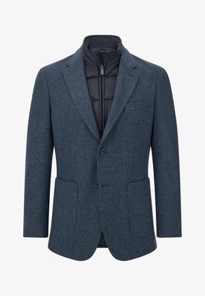 Blauwe tweed blazer met een gewatteerde zwarte voering, twee voorzakken, pieklapels en een enkele knoopsluiting. Geschikt om laagjes mee te dragen.
