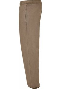 Brune, lette bukser med elastisk liv, sidelommer, innsnørt design og glatt tekstur. Egnet for hverdagsbruk.