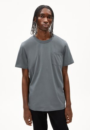 Grijze katoenen t-shirt met een ronde hals, korte mouwen en een borstzak. Het materiaal lijkt zacht met een gladde textuur. Eenvoudig ontwerp.
