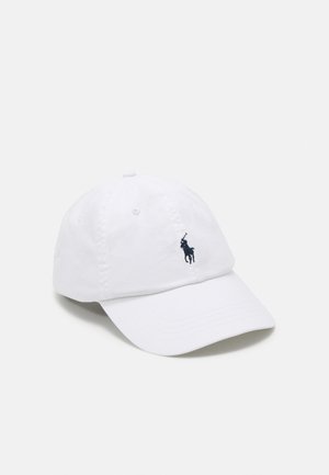 White cotton baseball cap with a curved brim and navy embroidered logo of a polo player on the front. Six ventilation eyelets on top.