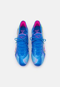 Scarpe sportive blu con finitura lucida, dotate di accenti rosa, motivi esagonali e una suola testurizzata; includono allacciatura tradizionale.