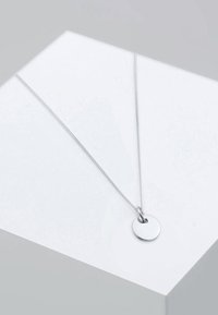 Silver necklace featuring a round pendant, smooth texture, and a fine chain. Pendant is simply designed with no additional patterns or accents.