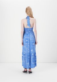 Blaues Maxikleid mit Halterbändern und rückenfreiem Design. Verfügt über florale und gemusterte Details, geraffte Taille und gestuften Saum.