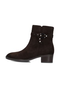 Bottes de cheville en suède marron avec un bout rond, une sangle décorative et des accents argentés, ainsi qu'un petit talon carré.