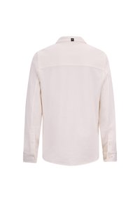 Lichtbeige langetermijnshirt met lange mouwen, geknoopte manchetten, kraagnek, gladde textuur, rugpasontwerp, minimale branding bij de nek.