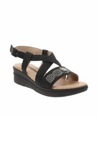 Sandal nero con suola a zeppa, con fasce incrociate e un elemento decorativo. Il materiale sembra sintetico con una superficie liscia.