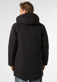 Black, insulated parka with a spacious hood, closed front, and side slits. Features a smooth, matte finish and minimal stitching details.