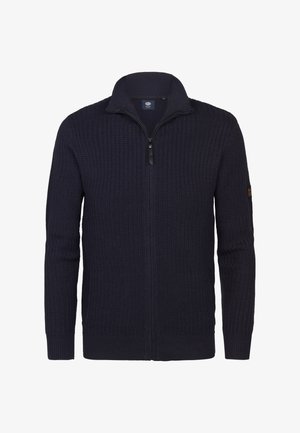 Pull-over zippé en tricot bleu marine avec un col haut, présentant un motif texturé et des poignets côtelés. Détail du logo sur la manche.