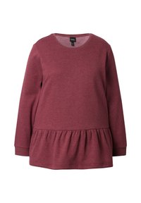 Top burdeos de manga larga con cuello redondo y dobladillo con volantes. Confeccionado en una tela suave y texturizada, presenta un ajuste relajado.