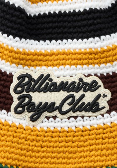 Close-up of a textured knit fabric with horizontal stripes in black, white, yellow, and brown, featuring a "Billionaire Boys Club" embroidered patch.