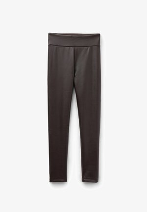 Leggings noirs avec une taille épaisse et lisse et un design ajusté et élégant. Fabriqués en tissu extensible et léger sans coutures visibles.