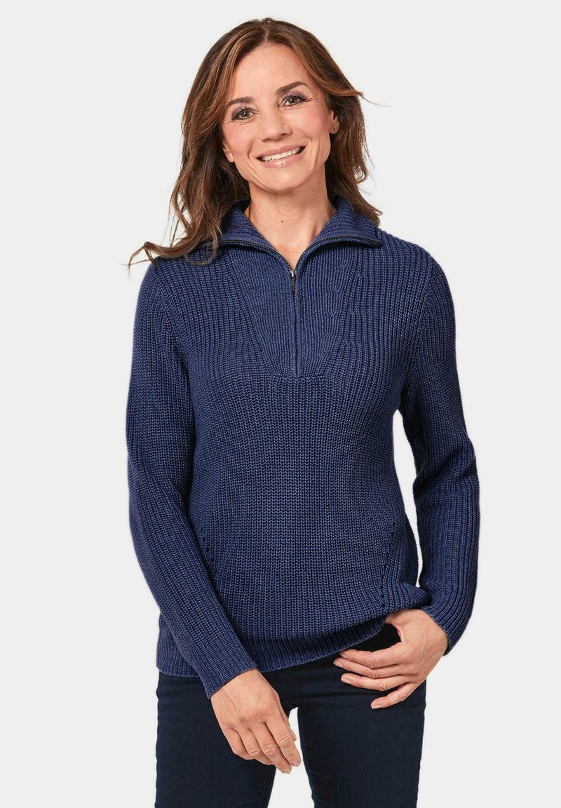 Marineblauer Strickpullover mit Reißverschlusskragen und gerippter Textur, mit einem legeren Schnitt und seitlichen Taschen.