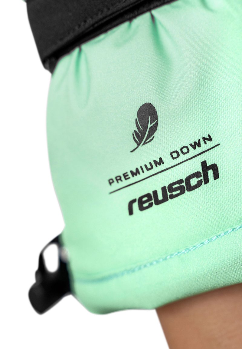 Light green fabric glove with black accents, featuring "PREMIUM DOWN" and "reusch" logos, smooth texture, and elastic gathering at wrist.