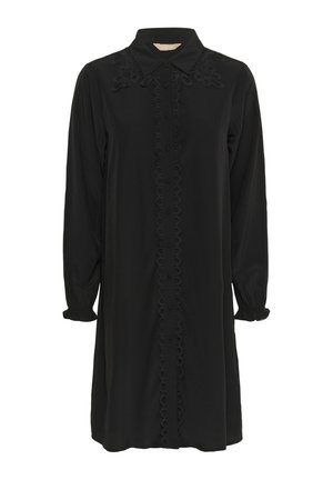 Black dress with long sleeves, buttoned front, and a collar. Features textured embroidery at the shoulders and a circular pattern down the center.