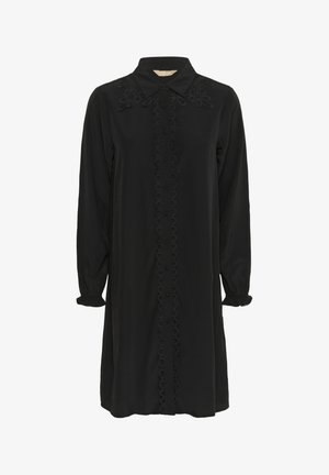 Rochie neagră cu mâneci lungi, închidere cu nasturi în față și guler. Prezintă broderie texturată la umeri și un model circular pe centrul rochiei.