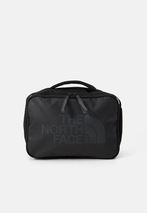 Black travel bag made of durable fabric with a rectangular shape, featuring a prominent logo and zippered closure. Two sturdy handles.