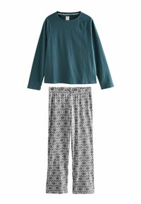 Elastisches türkisfarbenes Langarmoberteil mit Raglanärmeln, kombiniert mit pyjamaartigen Hosen in Schwarz und Weiß mit geometrischem Muster.