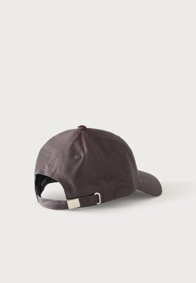 Casquette de baseball gris foncé vue de dos avec une sangle en tissu ajustable et une petite boucle en métal sur fond blanc.