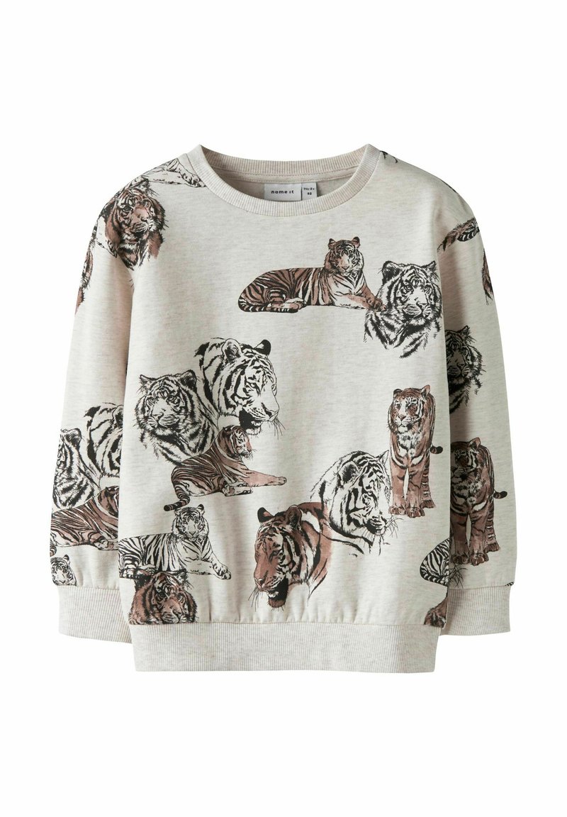 Gaiši pelēka džemperis ar dažādiem tīģera dizainiem brūnos un melnos toņos. Ērts audums ar ribotām aprocēm un apakšmalu.