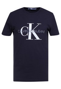 Námořnická modrá bavlněná tričko s bílým logem "CK" a textem "CALVIN KLEIN JEANS" v kontrastních odstínech. Krátké rukávy, kulatý výstřih.