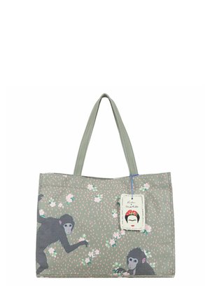 Sac cabas gris avec deux singes noirs et de petites fleurs blanches, avec une étiquette Frida Kahlo attachée à la poignée.