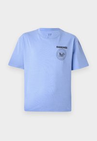 Light blue cotton t-shirt with short sleeves, round neck, and black "Ramones" logo print on the left chest area. Smooth texture.