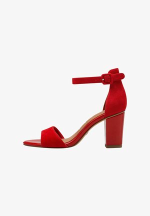 Red suede high-heeled sandal with a peep toe, ankle strap, and a chunky heel. Smooth, shiny sole accentuates the textured upper.