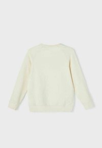 Cream-colored sweatshirt made of soft fabric, featuring a round neck, long sleeves, and ribbed cuffs with a simple, seamless design.