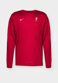 Langärmliges rotes Trikot aus leichtem Material mit einem weißen Nike-Logo und dem Wappen des Liverpool FC auf der linken Brust.