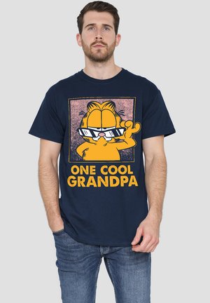 Navy blue cotton t-shirt featuring a graphic of a cartoon cat wearing sunglasses and the text “ONE COOL GRANDPA” in bold yellow font.