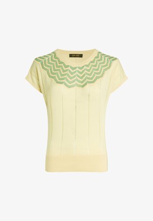 Light yellow knit sweater featuring a scalloped green and white patterned neckline, short sleeves, and ribbed hem with vertical lines.