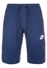 Blå Nike-träningsshorts med svarta dragsnören, fickor med dragkedja på sidorna och vit Nike-logotyp på vänster ben.