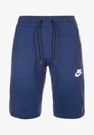 Pantalones cortos deportivos Nike en color azul con cordones negros, bolsillos laterales con cremallera y logotipo de Nike en blanco en la pierna izquierda.