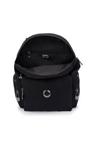 Black backpack with a smooth fabric exterior, zippered main compartment, front pocket, and a circular logo accent. Interior includes a zip pocket.
