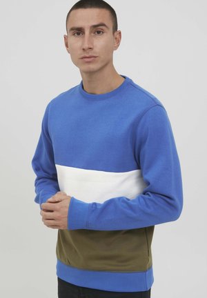 Blue and white color-blocked sweatshirt with a round neckline and ribbed cuffs. The lower section is olive green, made from soft material.