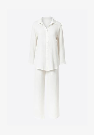 Completo bianco a due pezzi composto da camicia con bottoni e maniche lunghe e pantaloni a gamba larga. Tessuto strutturato con un delicato motivo arricciato.