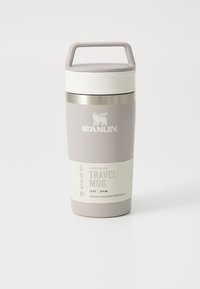 Vacuum insulated travel mug in light gray with a white lid, handle, and branded logo; designed for portability and thermal performance.