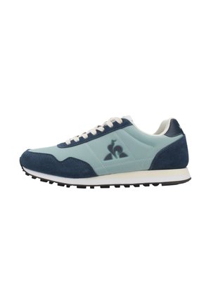 Light blue and navy sneaker with suede and leather materials, white laces, flat black sole, and a logo accent on the side.