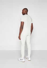 Björn Borg ESSENTIAL PANTS - Treningo apatinė dalis - cloud dancer