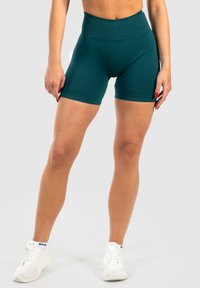 Teal hoge taille fietsshorts gemaakt van rekbare stof, met een gladde textuur en een strakke pasvorm, die eindigt halverwege de dij.