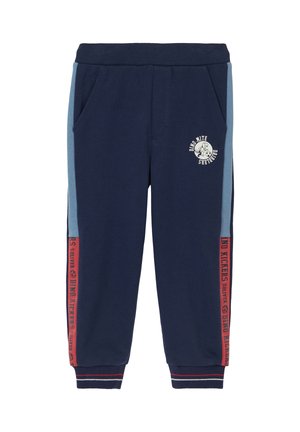 Marineblauwe joggingsbroek met een geribbelde tailleband, zijzakken, lichtblauwe panelen en rode accenten, voorzien van de tekst "Dino Kickers" en een logo.